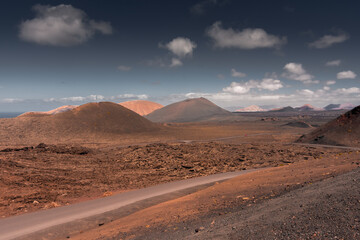 Empty road in the volcanic landscape of Timanfaya National Park, Lanzarote, Canary Islands,  Spain