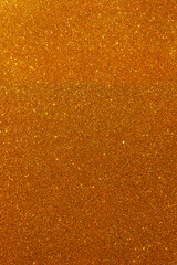 Background with sparkles. Backdrop with glitter. Shiny textured surface. Vertical image. Strong orange