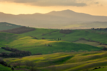 Amazing sunrise over the green hills of the Tuscany countryside,  Italy