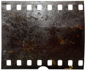 Old fashioned 35mm filmstrip or dia slide frame with burned surface..