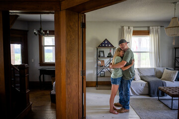 Marine veteran at home sharing a moment with wife. - obrazy, fototapety, plakaty