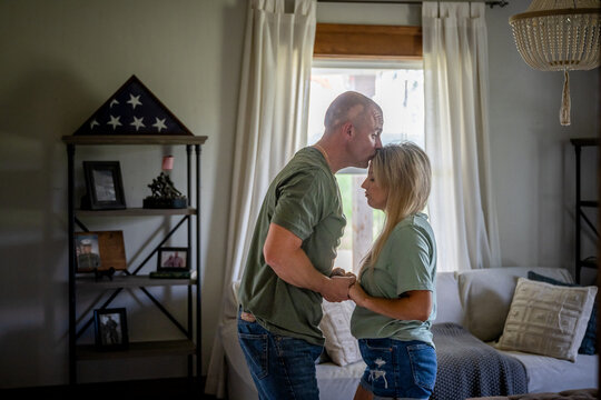 Marine veteran at home sharing a moment with wife.