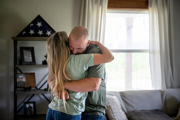 Marine veteran at home sharing a moment with wife. - obrazy, fototapety, plakaty