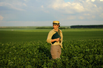 The farmer controls the quality of the potato crop. Female agronomist in agriculture.