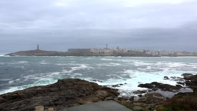 Panoramic view of A Coru&ntilde;a with the sea, the Tower of Hercules and the bay with the beaches of Orzan and Riazor with light morning mist