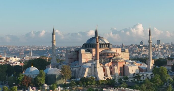 Istanbul, Turkey. Sultanahmet with the Blue Mosque and the Hagia Sophia with a Golden Horn on the background at sunrise. Cinematic Aerial view.