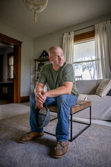 Marine veteran at home with family poses for portrait.