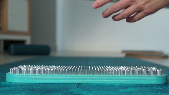 Open and put sadhu board for sadhu yoga practice. Get up on nails. Board with needles, side view. The concept of a healthy practice of sadhu yoga.