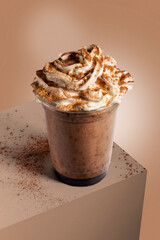 chocolate milkshake in plastic glass on a brown background. Chocolate milkshake in takeaway cup, old beverage tasty. Refreshment food. Social media content for restaurant, flyer, brouchure