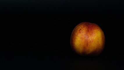 nectarine fruit on black background