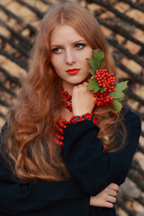 Fototapeta premium Beautiful Woman in traditional Ukrainian style. Ukrainian National Costume. Gorgeous young Woman with red lips. Portrait attractive Girl with a red necklace. Slavonic Girl with long blond hair.