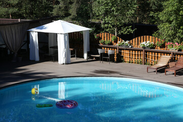 Outdoor swimming pool and spa massage room in hotel