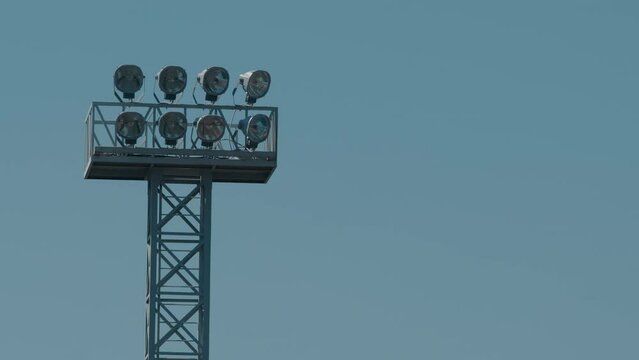 High floodlight in the stadium in the summer daytime. Air heat