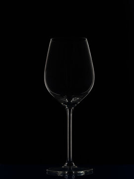 Glass wine glass on a black background.