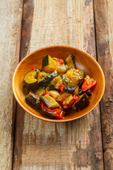 A plate of grilled vegetables on a wooden table.copy space.