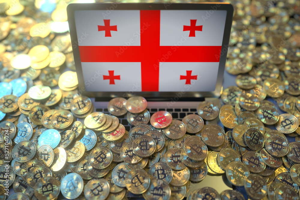 Aufkleber computer with flag of georgia and pile of bitcoins. national regulations and cryptocurrency mining c