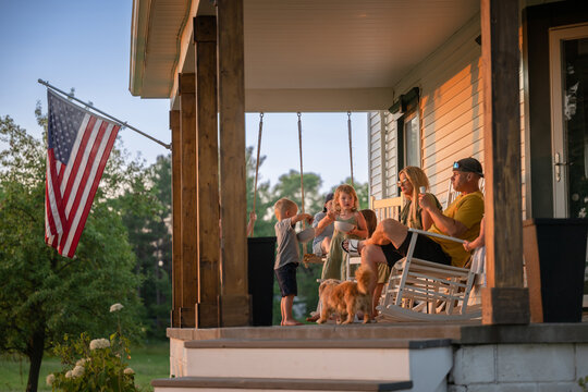 Marine veteran at home with family during sunset on front porch.