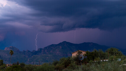 Lightning bolt and monsoon storm clouds over the Catalina Mountains in the Sonoran Desert north of...