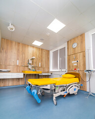 Clean emergency room of modern clinic Empty hospital bed and various first aid medical equipment.