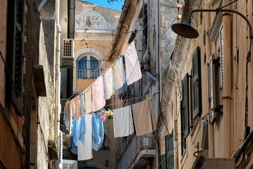 View of Corfu town with laundry hanging on clotheslines outside the buildings - obrazy, fototapety, plakaty