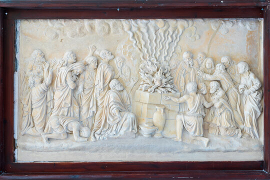 HAIFA, ISRAEL. June 26, 2022: Muhraka monastery of the Carmelite on the Carmel mount . Bas-relief depicting the priests of Baal at the altar and prophet Elijah