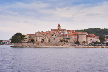 Fototapeta na wymiar Beautiful old historic city Korcula on the island Korcula in south dalmatia region in Croatia. Picture taken during the cloudy summer day from the sea. Place to spend summer vacation in south Europe.