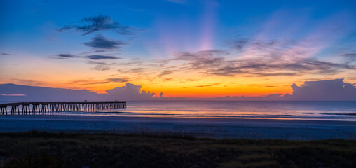 Sunrise over the Atlantic Ocean and the Jacksonville Baech pier in Jacksonville Beach Florida USA