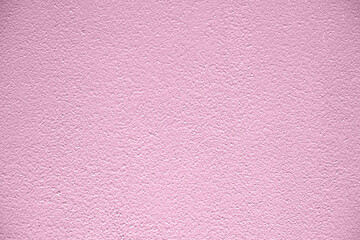 Fototapeta premium Saturated pastel light pink colored low contrast Concrete textured background. Empty colourful wall texture with copy space for text overlay and mockups. 2023, 2024 color trend