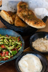 Israel and Lebanon cuisine served in restaurant. Middle eastern or Arabic Oriental restaurant. Several appetizer dishes and spreads for bread  and salad. 