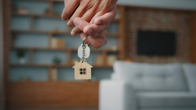 Unrecognizable Caucasian married couple spouses owners with key from buying house receiving mortgage loan bank credit closeup female and male hands holding bunch of keys from new apartment real estate