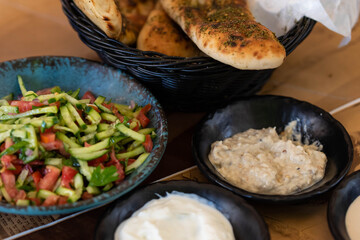 Israel and Lebanon cuisine served in restaurant. Middle eastern or Arabic Oriental restaurant. Several appetizer dishes and spreads for bread  and salad. 