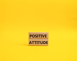 Positive attitude symbol. Concept words Positive attitude on wooden blocks. Beautiful yellow background. Business and Positive attitude concept. Copy space.