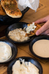 Israel and Lebanon cuisine served in restaurant. Middle eastern or Arabic Oriental restaurant. Several appetizer dishes and spreads for bread  and salad. 