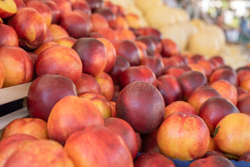 Heap of ripe nectarines on street food market