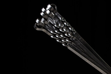 Steel skewers on a black background. Tools for barbecue