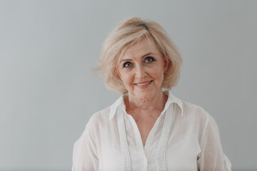 Elderly caucasian old aged woman portrait gray haired smiling portrait