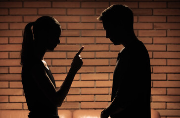 Woman wife pointing finger scolding, nagging her husband man. Bad relationship, jealousy, cheating...