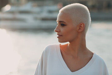 Portrait profile of young smiling millenial european short haired woman. Beautiful happy blonde...