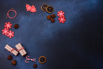 Fototapeta na wymiar Elements of Christmas decorations, sweets and gingerbread on a wooden cutting board
