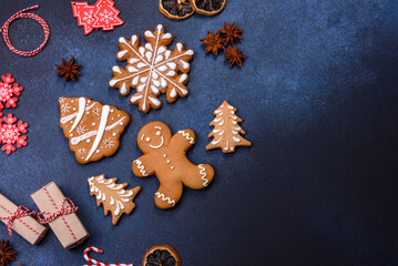 Elements of Christmas decorations, sweets and gingerbread on a wooden cutting board