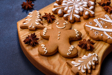 Elements of Christmas decorations, sweets and gingerbread on a wooden cutting board