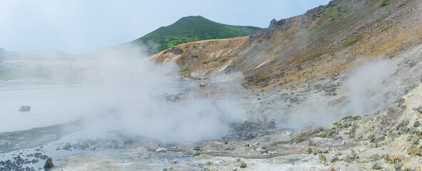 steaming hydrothermal outlet on the shore of the hot lake in the caldera of the Golovnin volcano on the island of Kunashir
