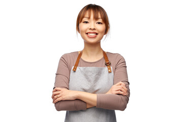 cooking, culinary and people concept - happy smiling female chef or waitress in apron with crossed...