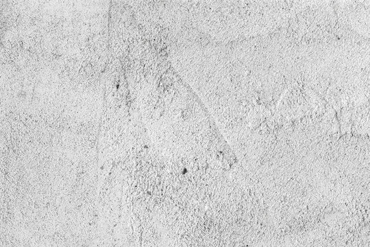 Heavily textured white and gray stucco, adobe or concrete wall for ad copy space, composite background or layer overlay