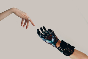 Male hand prosthesis cyborg reaching to female human white hand. Hands touching progress concept - obrazy, fototapety, plakaty
