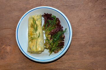 fried stuffed spring rolls on a plate .
