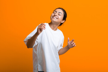 Portrait of young adult happy dancing indian woman in T-shirt - Powered by Adobe