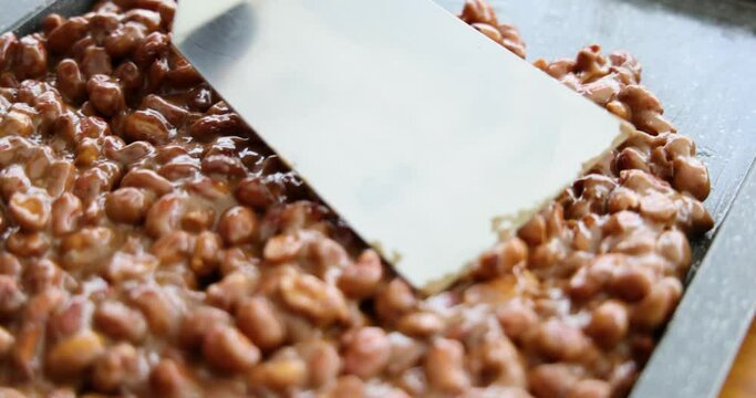 artisanal production of very traditional sweets in the region of Minas Gerais and Goiania made with peanuts, sugar and butter forming a plate that is then cut into cubes
