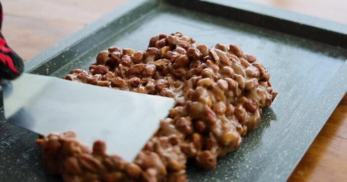 artisanal production of very traditional sweets in the region of Minas Gerais and Goiania made with peanuts, sugar and butter forming a plate that is then cut into cubes