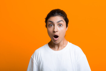 Portrait of young surprised scared adult indian woman in T-shirt